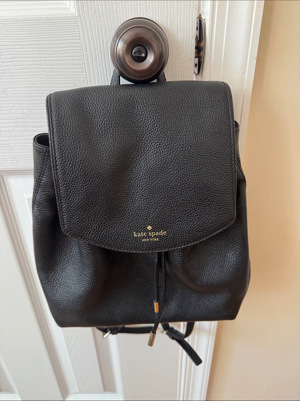 kate spade Black Pebbled Leather Drawstring Backpack with Gold Accent